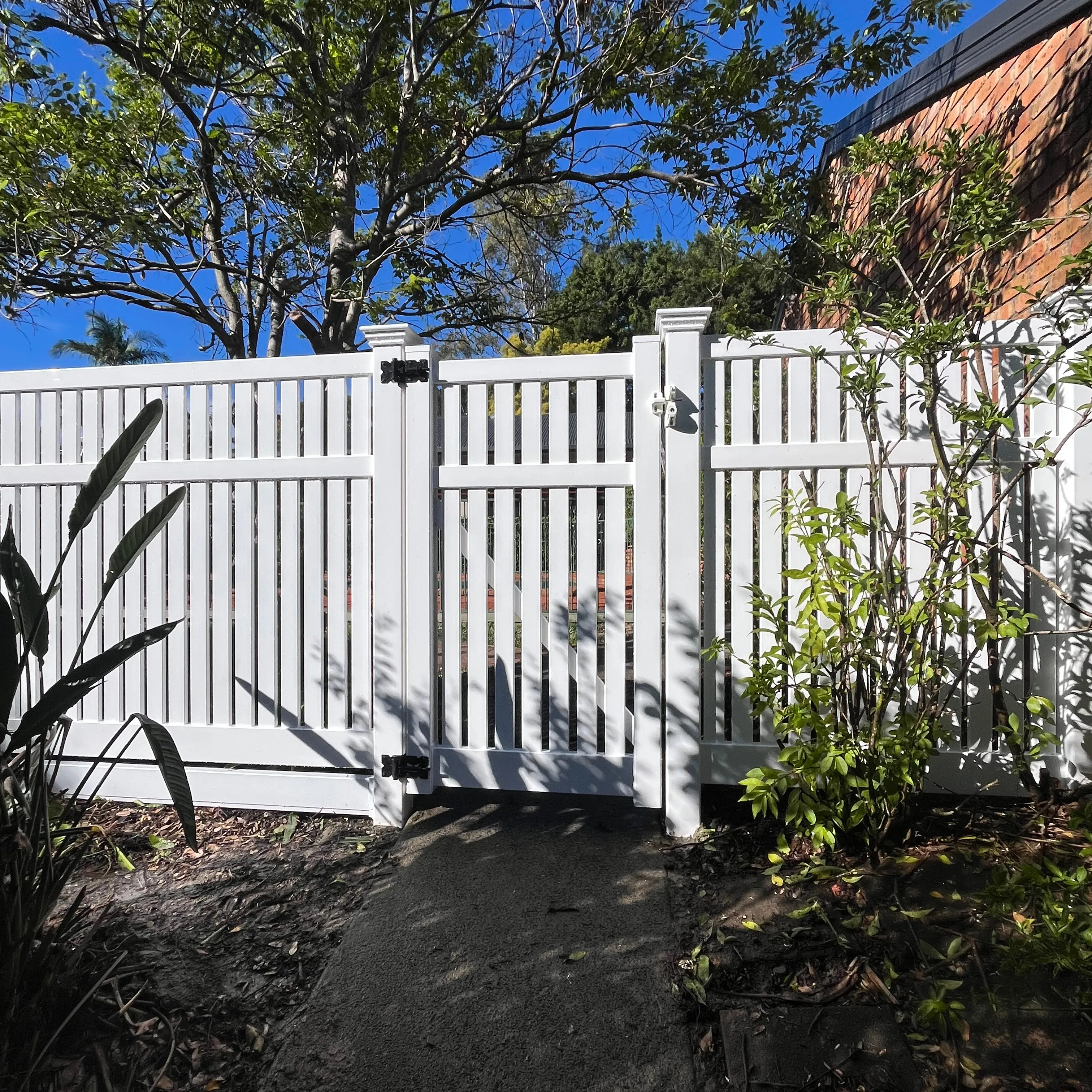 White double gate and matching vertical-slat garden fence