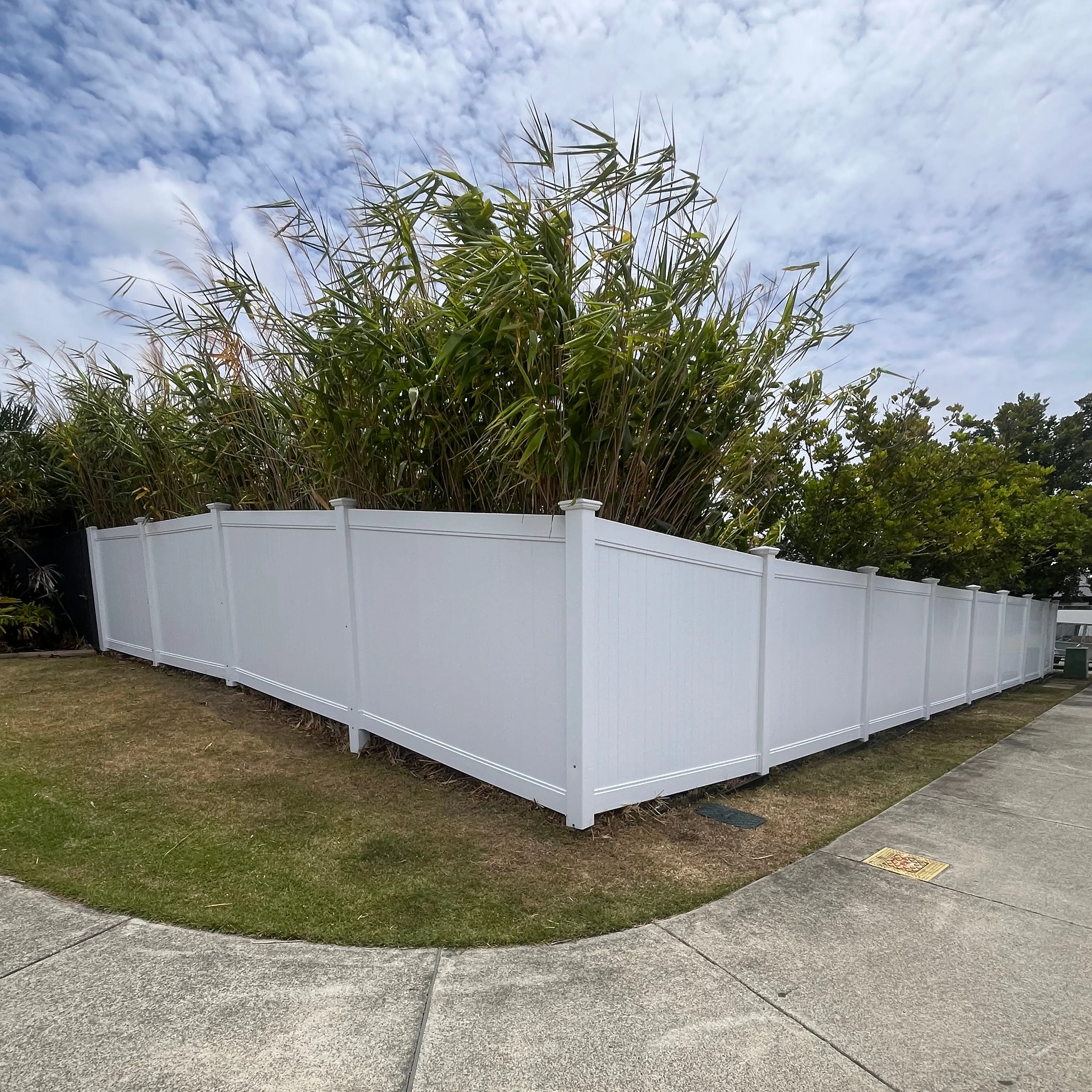 White privacy fence wrapping around a corner yard